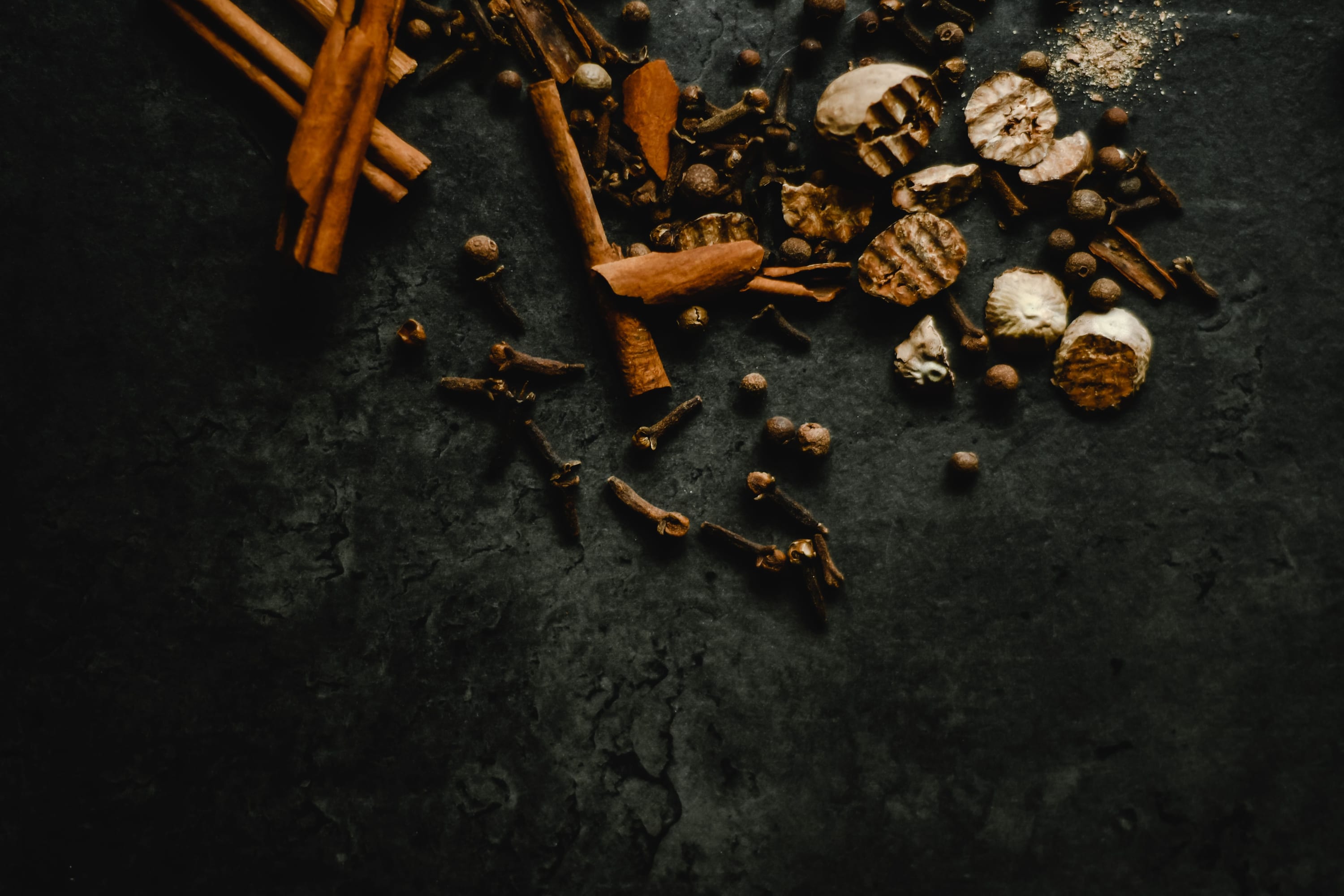 Calm wellness ritual still life — botanicals and amber-glass apothecary bottles